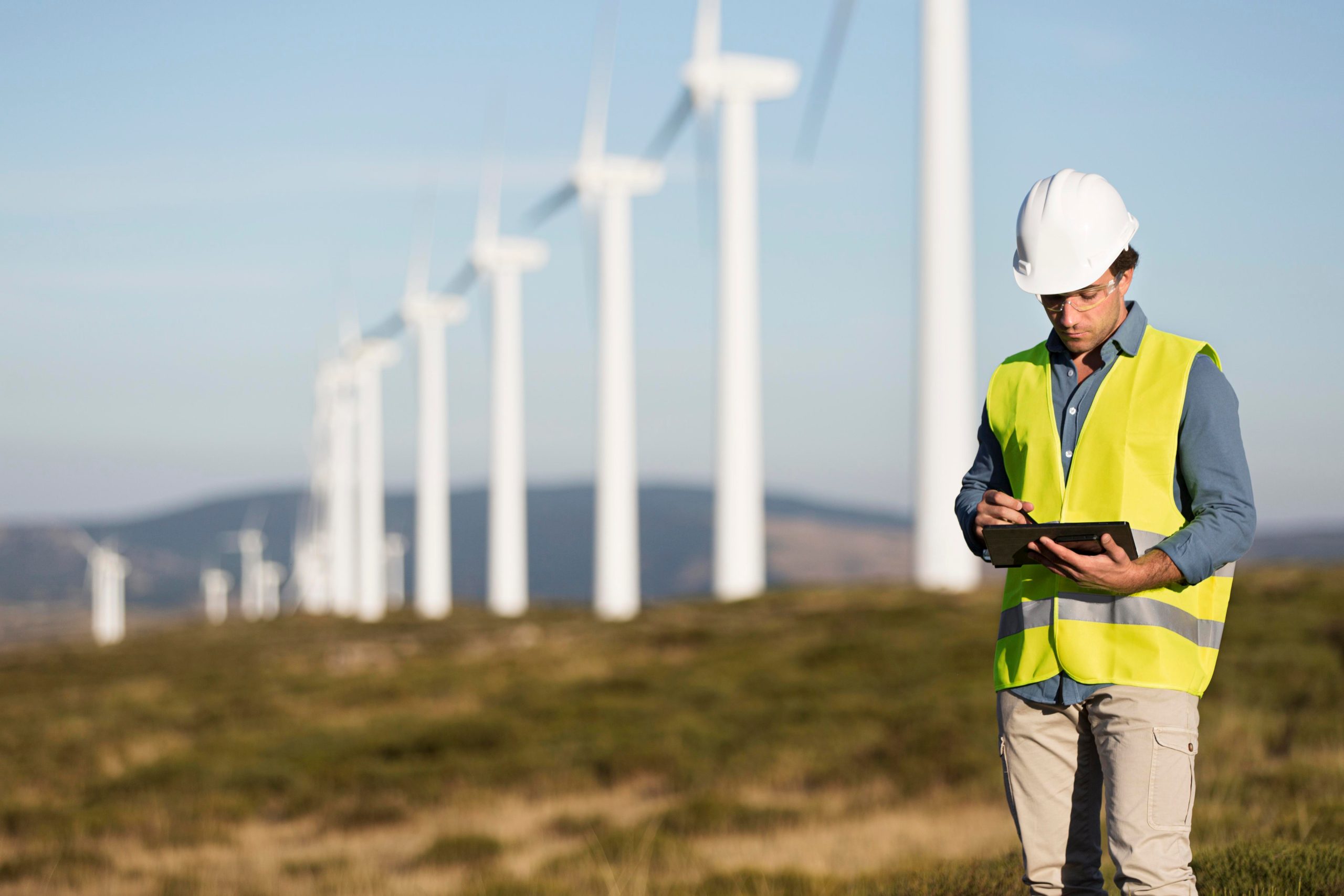 Wind energy technician using a tablet